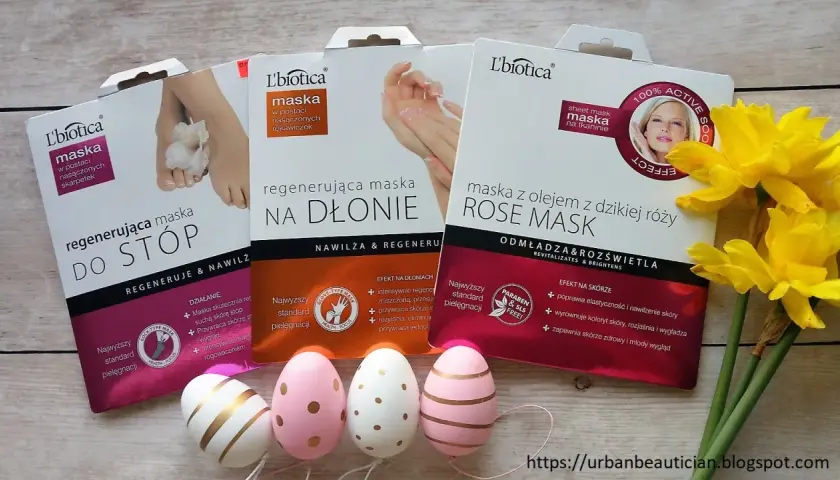 Zestaw masek do stóp, dłoni i twarzy L'biotica z olejkiem z dzikiej róży. Obok wielkanocne pisanki i żonkile.
